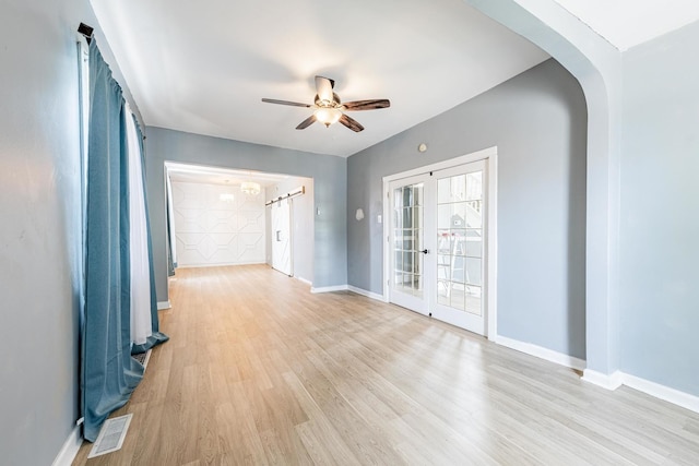 7115 S Rockwell St, Chicago, IL 60629 - unfurnished room featuring arched walkways, ceiling fan, light wood-style floors, and baseboards