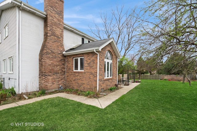 735 Vermont Rd, Frankfort, IL 60423 - view of home's exterior featuring a chimney, brick siding, and a patio