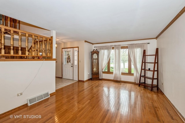 735 Vermont Rd, Frankfort, IL 60423 - unfurnished living room featuring hardwood / wood-style floors, baseboards, and ornamental molding