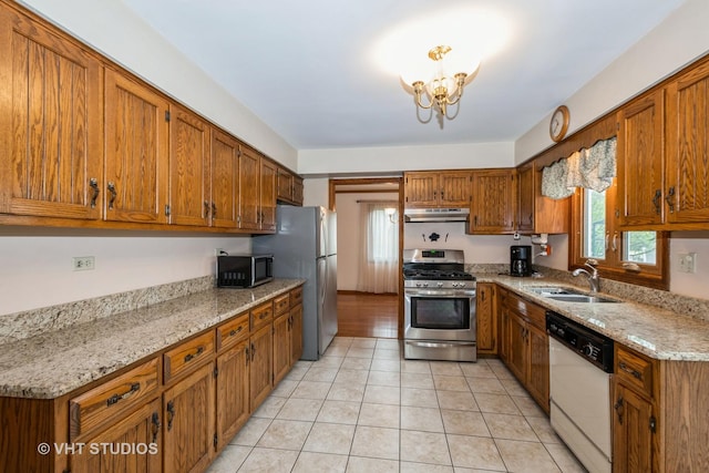 735 Vermont Rd, Frankfort, IL 60423 - kitchen featuring stainless steel appliances, a sink, under cabinet range hood, brown cabinetry, and light tile patterned floors