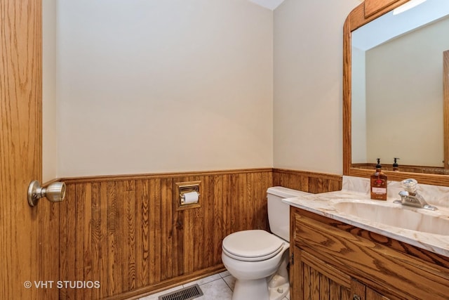 735 Vermont Rd, Frankfort, IL 60423 - half bath featuring a wainscoted wall, vanity, toilet, tile patterned flooring, and wooden walls