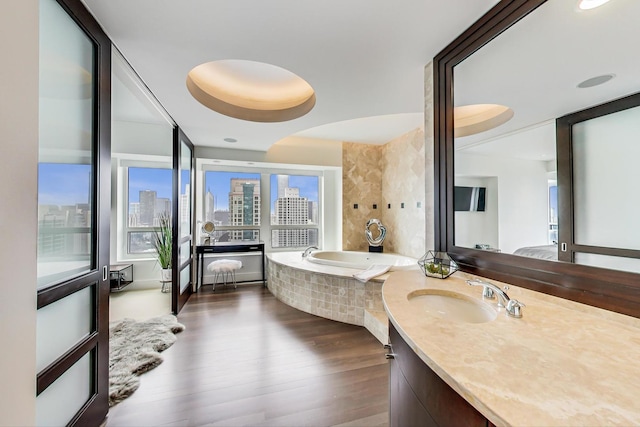 800 N Michigan Ave Unit 4801, Chicago, IL 60611 - bathroom featuring healthy amount of natural light, a bath, vanity, and wood finished floors