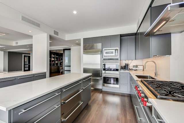 800 N Michigan Ave Unit 4801, Chicago, IL 60611 - kitchen featuring built in appliances, gray cabinets, a sink, wall chimney range hood, and light countertops