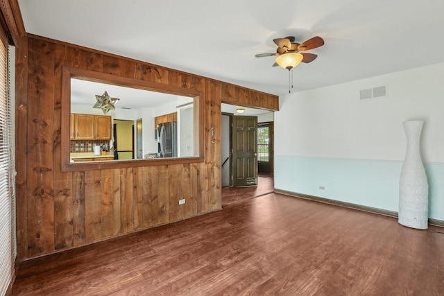 143 Hesterman Dr, Glendale Heights, IL 60139 - unfurnished room with wooden walls, dark wood-style flooring, ceiling fan, and baseboards