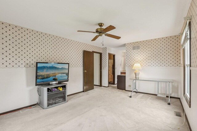 143 Hesterman Dr, Glendale Heights, IL 60139 - living area featuring wallpapered walls, a ceiling fan, carpet, and wainscoting