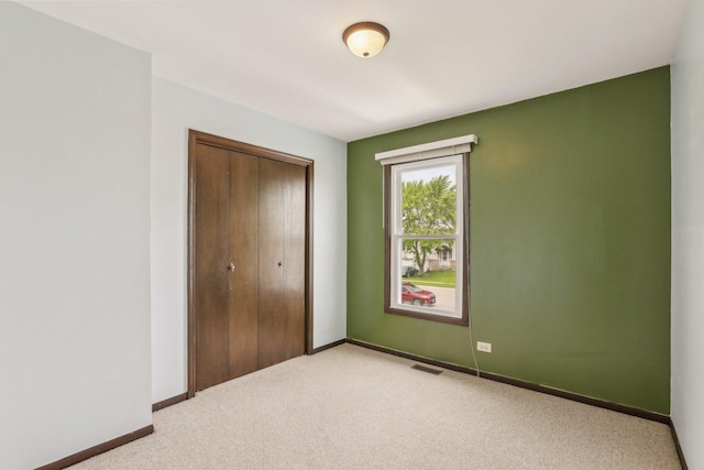 143 Hesterman Dr, Glendale Heights, IL 60139 - unfurnished bedroom featuring light carpet, a closet, and baseboards