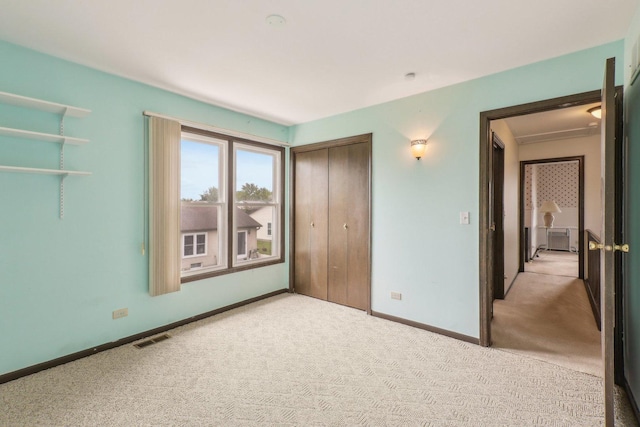 143 Hesterman Dr, Glendale Heights, IL 60139 - unfurnished bedroom featuring carpet flooring, a closet, and baseboards