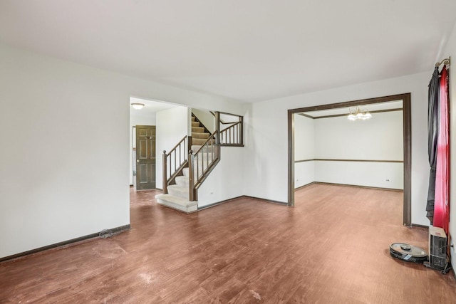 143 Hesterman Dr, Glendale Heights, IL 60139 - unfurnished living room featuring wood finished floors, stairway, and baseboards