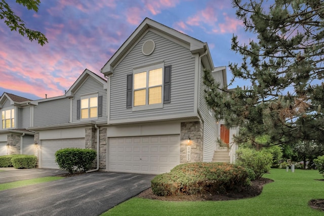 2422 Georgetown Cir, Aurora, IL 60503 - view of front of property with stone siding, an attached garage, asphalt driveway, and a yard