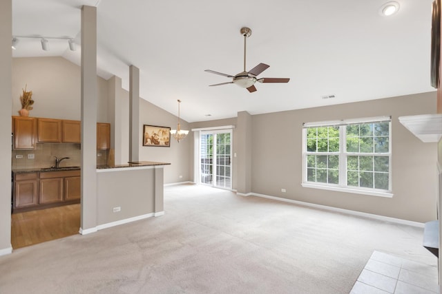 2422 Georgetown Cir, Aurora, IL 60503 - unfurnished living room featuring light colored carpet, a ceiling fan, baseboards, healthy amount of natural light, and high vaulted ceiling