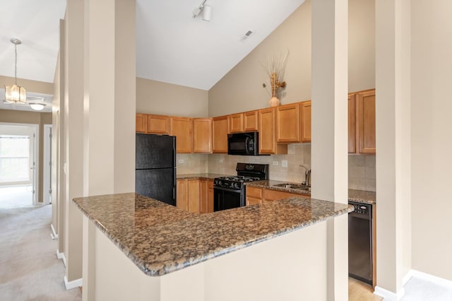 2422 Georgetown Cir, Aurora, IL 60503 - kitchen featuring black appliances, a sink, decorative backsplash, dark stone counters, and high vaulted ceiling