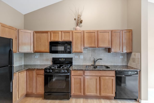 2422 Georgetown Cir, Aurora, IL 60503 - kitchen featuring black appliances, a sink, dark stone counters, backsplash, and high vaulted ceiling