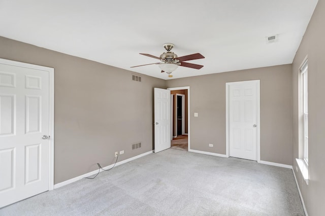 2422 Georgetown Cir, Aurora, IL 60503 - unfurnished bedroom featuring baseboards, carpet, a ceiling fan, and multiple windows