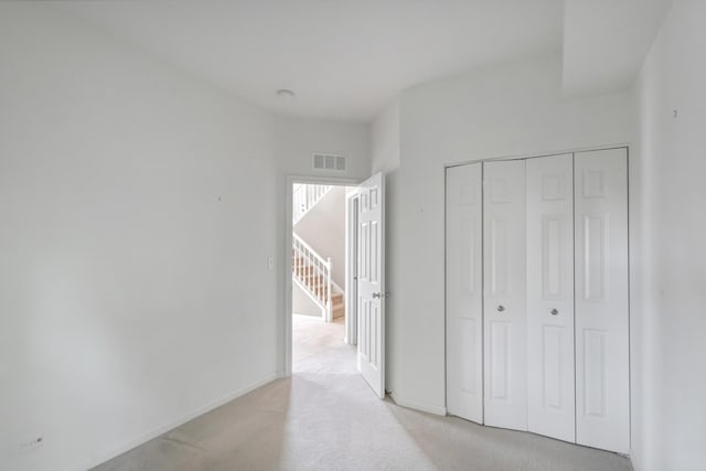 2422 Georgetown Cir, Aurora, IL 60503 - unfurnished bedroom with light colored carpet, a closet, and baseboards