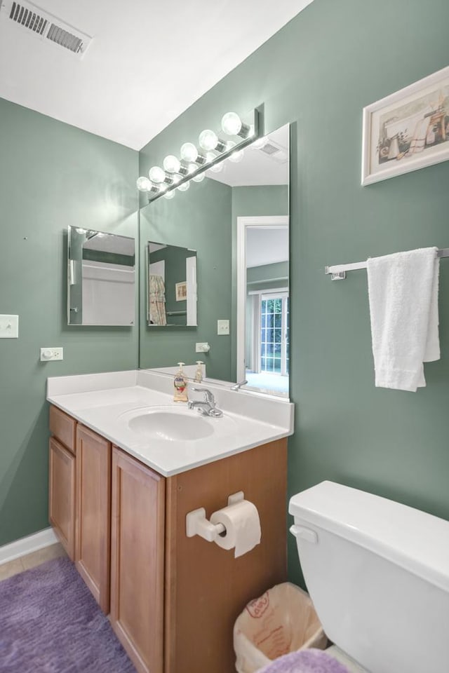 2422 Georgetown Cir, Aurora, IL 60503 - half bathroom with toilet, vanity, and tile patterned floors