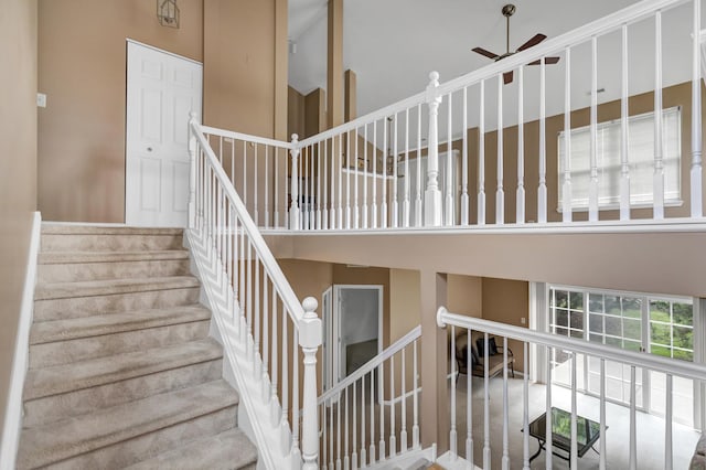 2422 Georgetown Cir, Aurora, IL 60503 - stairs featuring ceiling fan and a towering ceiling