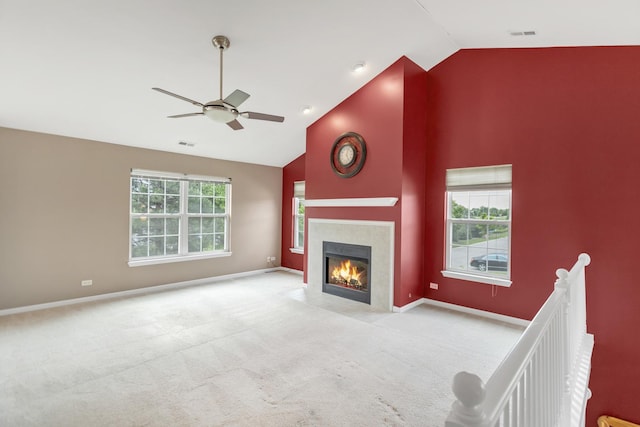 2422 Georgetown Cir, Aurora, IL 60503 - unfurnished living room featuring carpet floors, a ceiling fan, a tiled fireplace, baseboards, and high vaulted ceiling