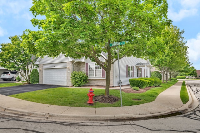 1039 Stewart Ct, Joliet, IL 60431 - obstructed view of property featuring brick siding, a front lawn, asphalt driveway, and a garage