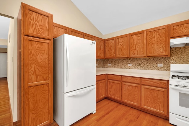 1039 Stewart Ct, Joliet, IL 60431 - kitchen featuring white appliances, light countertops, light wood-style flooring, vaulted ceiling, and decorative backsplash