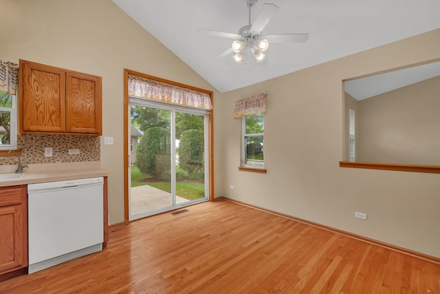 1039 Stewart Ct, Joliet, IL 60431 - unfurnished dining area with lofted ceiling, light wood-type flooring, a ceiling fan, a sink, and baseboards