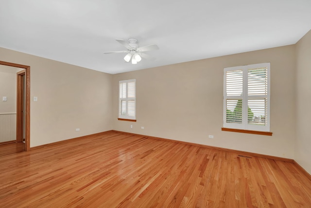 1039 Stewart Ct, Joliet, IL 60431 - unfurnished room featuring light wood-style flooring, a ceiling fan, and baseboards