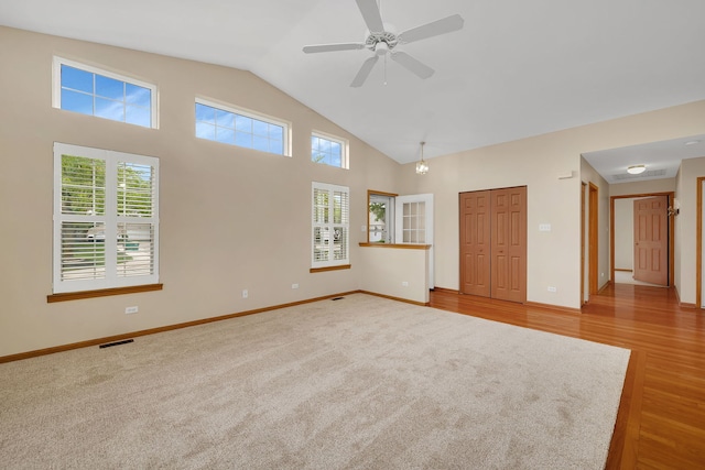 1039 Stewart Ct, Joliet, IL 60431 - spare room with a ceiling fan, wood finished floors, baseboards, high vaulted ceiling, and carpet floors