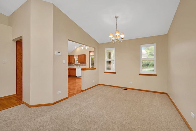 1039 Stewart Ct, Joliet, IL 60431 - empty room with light carpet, baseboards, a chandelier, and lofted ceiling