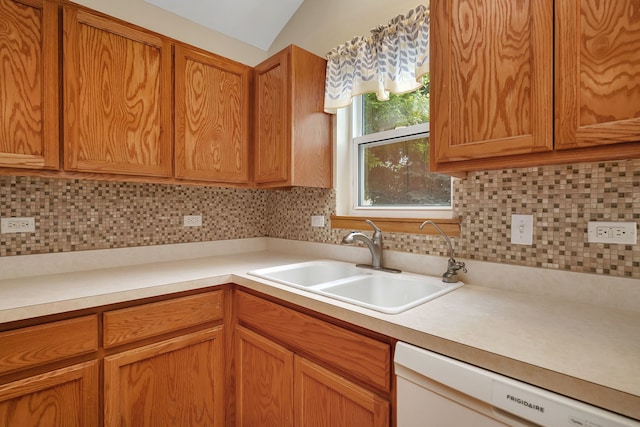 1039 Stewart Ct, Joliet, IL 60431 - kitchen with white dishwasher, a sink, light countertops, tasteful backsplash, and lofted ceiling