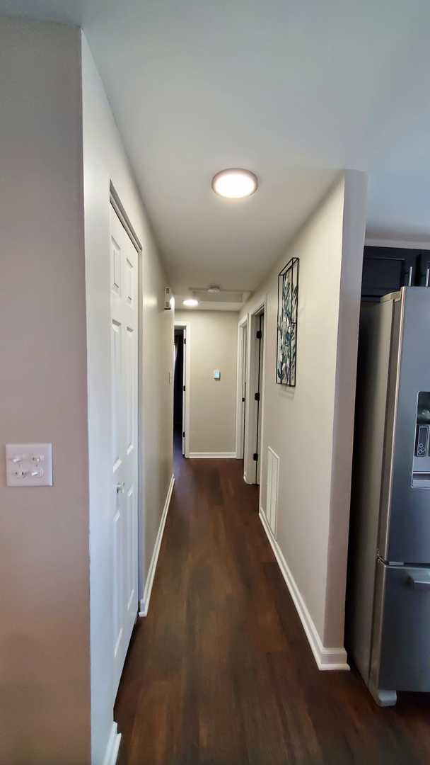 1427 Hampton Ln, Schaumburg, IL 60193 - hallway with baseboards and wood finished floors