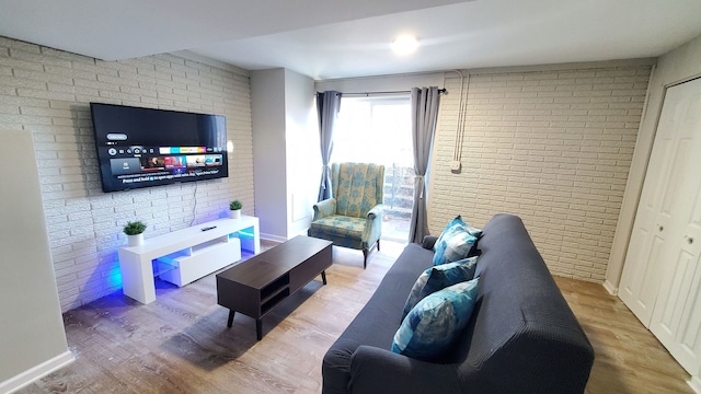 1427 Hampton Ln, Schaumburg, IL 60193 - living room with brick wall, wood finished floors, and baseboards