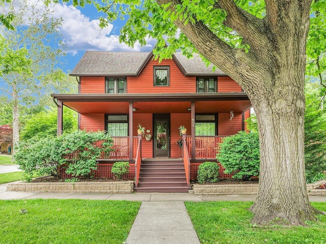 611 S Lynn St, Champaign, IL 61820 - rustic home featuring a porch and a shingled roof