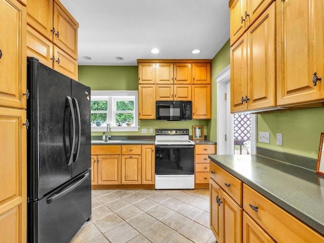 611 S Lynn St, Champaign, IL 61820 - kitchen with black appliances, dark countertops, a sink, recessed lighting, and light tile patterned floors