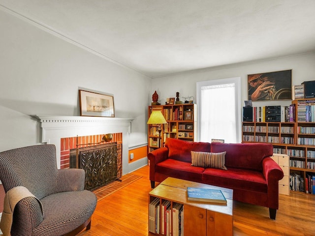 611 S Lynn St, Champaign, IL 61820 - living area with a fireplace, wood finished floors, and crown molding