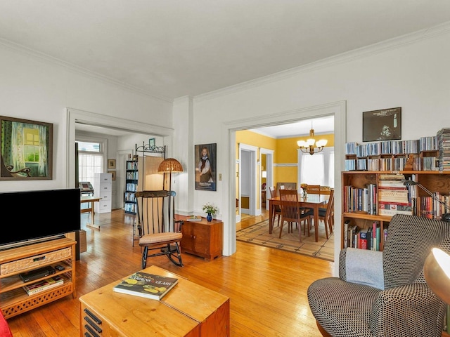 611 S Lynn St, Champaign, IL 61820 - living room with ornamental molding, light wood-type flooring, and a chandelier