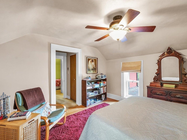 611 S Lynn St, Champaign, IL 61820 - bedroom featuring vaulted ceiling, baseboards, wood finished floors, and ceiling fan