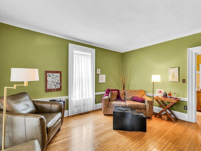 611 S Lynn St, Champaign, IL 61820 - living area featuring ornamental molding, wood-type flooring, and baseboards