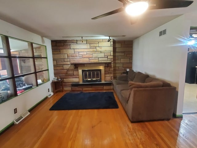3771 Emerald Ave, Steger, IL 60475 - living room with a ceiling fan, wood finished floors, rail lighting, and a fireplace