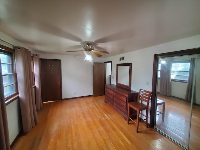 3771 Emerald Ave, Steger, IL 60475 - unfurnished dining area with light wood-style floors, ceiling fan, and baseboards