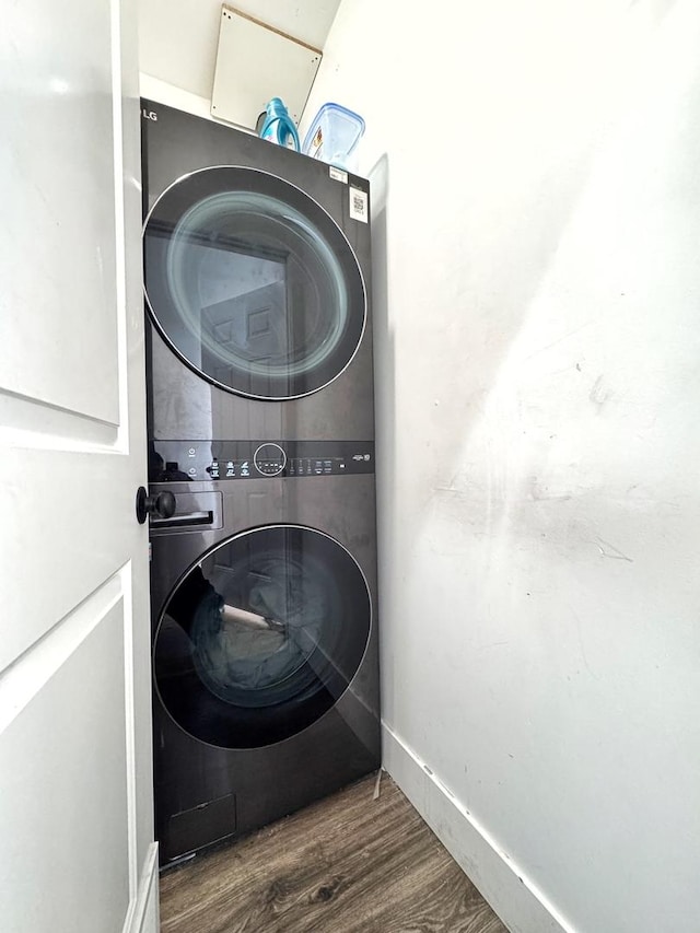 3316 W Flournoy St, Chicago, IL 60624 - laundry room with stacked washer and clothes dryer, wood finished floors, and baseboards