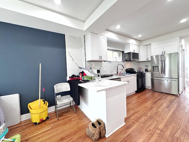 3316 W Flournoy St, Chicago, IL 60624 - kitchen with stainless steel appliances, a sink, white cabinetry, tasteful backsplash, and recessed lighting