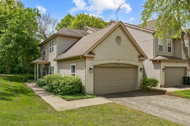 5261 Pebble Ln, Crystal Lake, IL 60012 - view of front facade featuring a shingled roof, a front lawn, asphalt driveway, and brick siding