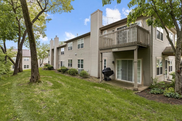 5261 Pebble Ln, Crystal Lake, IL 60012 - back of house with a balcony, a yard, a chimney, and a patio