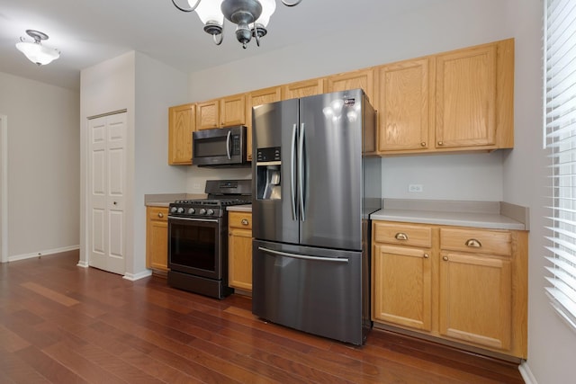 5261 Pebble Ln, Crystal Lake, IL 60012 - kitchen featuring appliances with stainless steel finishes, dark wood-type flooring, a chandelier, and light countertops
