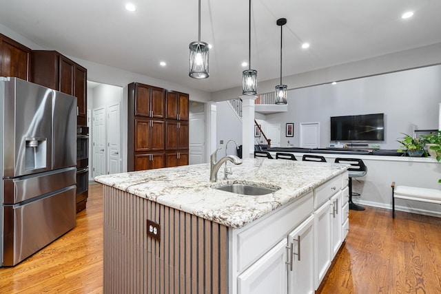24723 W Champion Dr, Plainfield, IL 60585 - kitchen with stainless steel fridge, a sink, light wood finished floors, a center island with sink, and recessed lighting