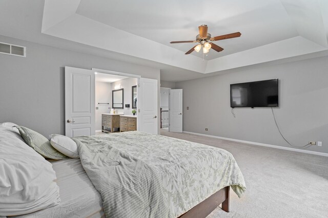 24723 W Champion Dr, Plainfield, IL 60585 - bedroom featuring a tray ceiling, carpet, baseboards, connected bathroom, and ceiling fan