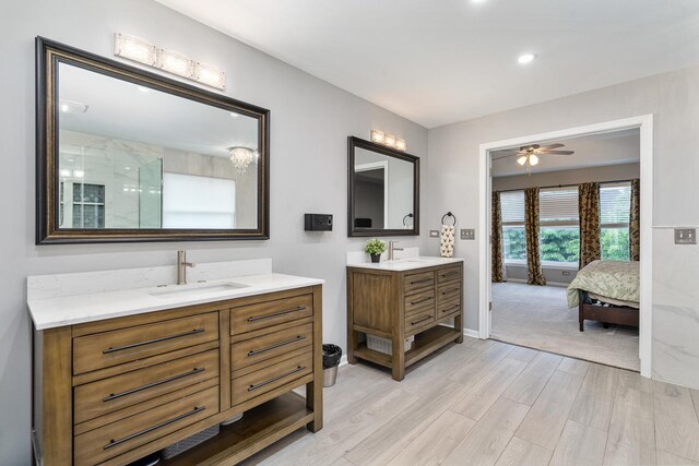 24723 W Champion Dr, Plainfield, IL 60585 - bathroom with wood finished floors, ensuite bath, two vanities, ceiling fan, and a shower