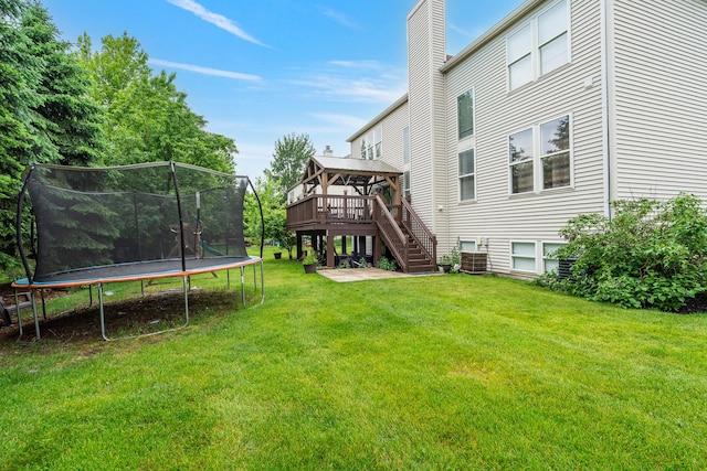 24723 W Champion Dr, Plainfield, IL 60585 - view of grassy yard featuring a trampoline, a gazebo, stairs, central AC, and a wooden deck