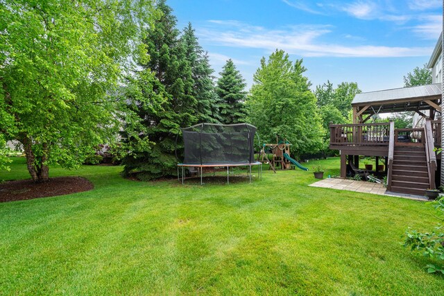 24723 W Champion Dr, Plainfield, IL 60585 - view of grassy yard with a trampoline, a playground, stairs, and a deck
