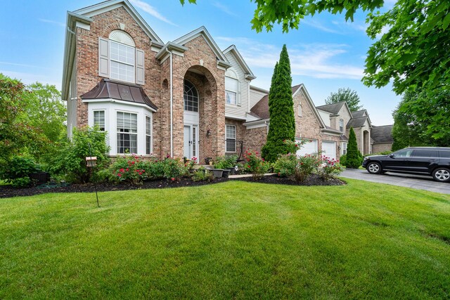 24723 W Champion Dr, Plainfield, IL 60585 - traditional-style house featuring asphalt driveway, a front yard, and brick siding