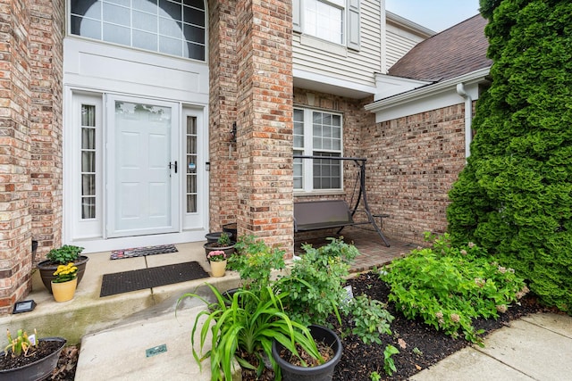 24723 W Champion Dr, Plainfield, IL 60585 - view of exterior entry with brick siding and a shingled roof